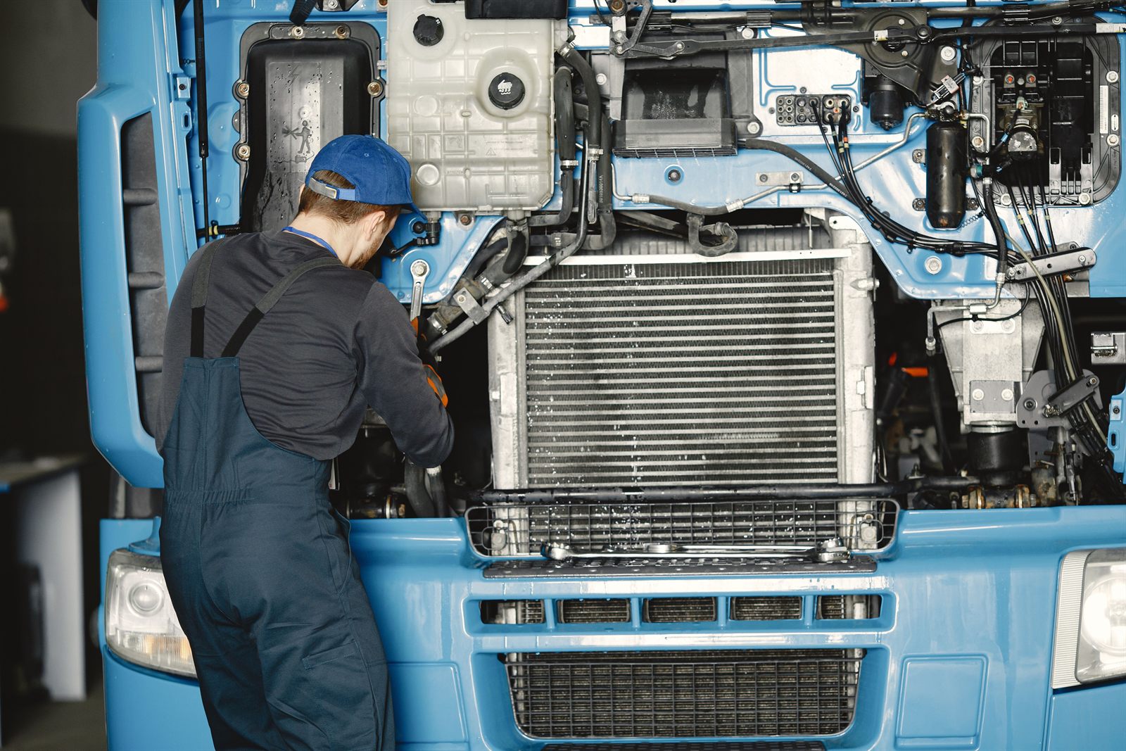 Mechanic servicing a truck — maintenance scheduling